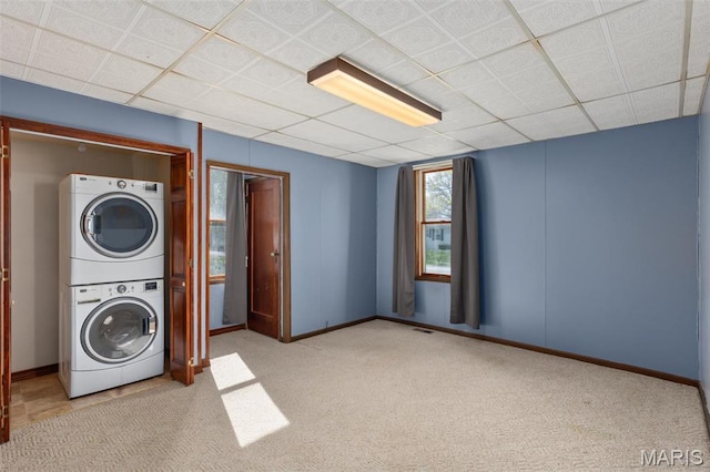 823 E Pearl St, Staunton, IL 62088 - laundry area with stacked washing machine and dryer, carpet, and baseboards