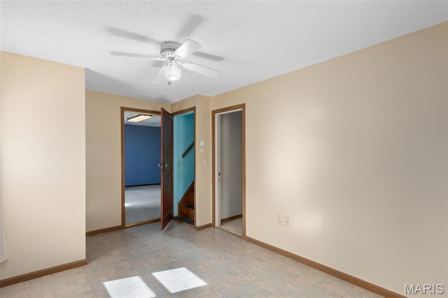 823 E Pearl St, Staunton, IL 62088 - unfurnished bedroom featuring baseboards, ceiling fan, and a textured ceiling
