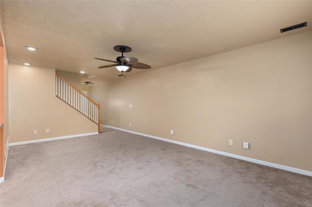 carpeted empty room featuring a ceiling fan, baseboards, stairway, and recessed lighting