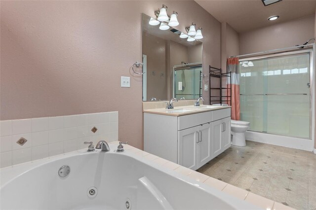 full bath featuring a jetted tub, a stall shower, double vanity, and toilet