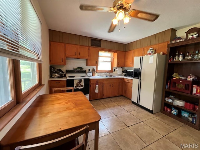 932 State Highway Hh, Isabella, MO 65676 - kitchen featuring white refrigerator with ice dispenser, range with electric cooktop, light countertops, a ceiling fan, and light tile patterned floors