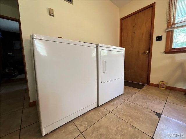 932 State Highway Hh, Isabella, MO 65676 - laundry area featuring washer and clothes dryer and light tile patterned floors