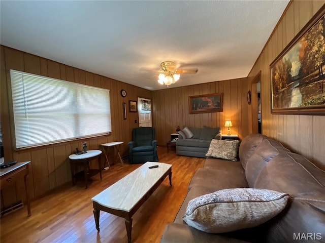 932 State Highway Hh, Isabella, MO 65676 - living area featuring light wood-style floors, a ceiling fan, and wooden walls