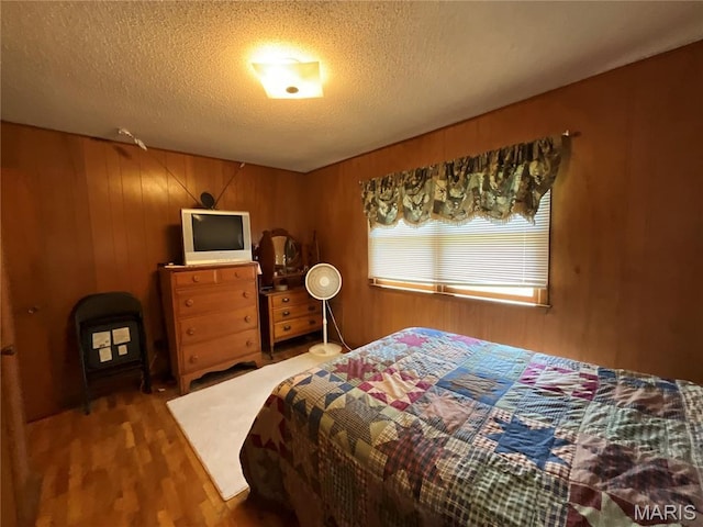 932 State Highway Hh, Isabella, MO 65676 - bedroom with wood finished floors, a textured ceiling, and wood walls