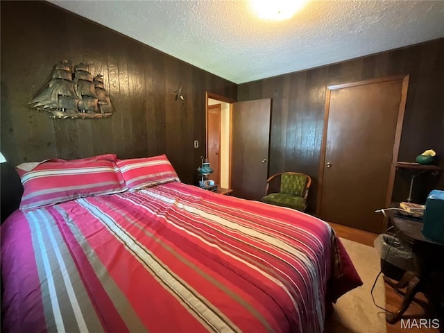 932 State Highway Hh, Isabella, MO 65676 - bedroom featuring a textured ceiling, wooden walls, and a closet