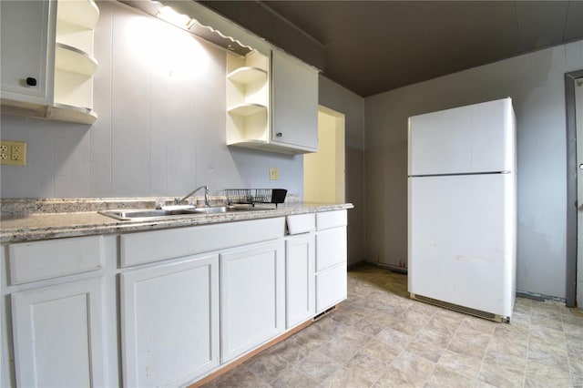1103 S Madison St, Gillespie, IL 62033 - kitchen with freestanding refrigerator, open shelves, and white cabinetry