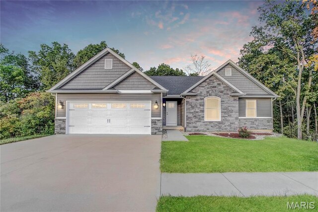 1127 Redwing Ct, Grafton, IL 62037 - craftsman inspired home with stone siding, concrete driveway, an attached garage, and a front yard