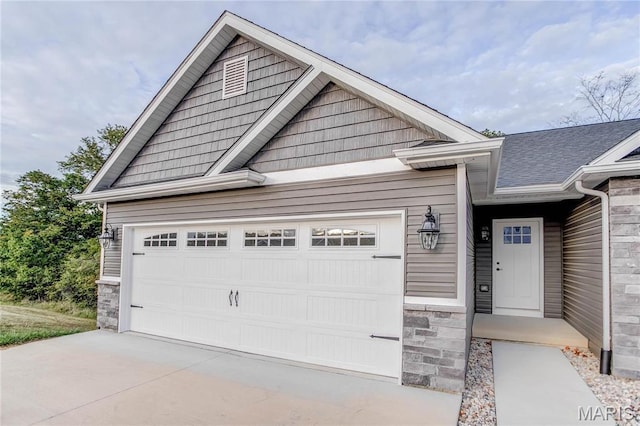 1127 Redwing Ct, Grafton, IL 62037 - view of front facade featuring stone siding and a garage