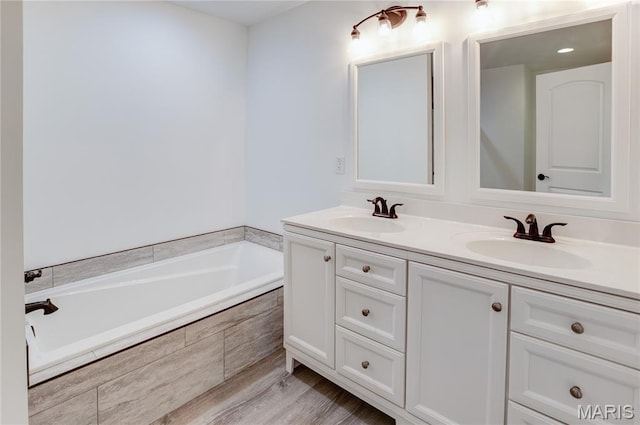1127 Redwing Ct, Grafton, IL 62037 - full bath with double vanity, a garden tub, and wood finished floors
