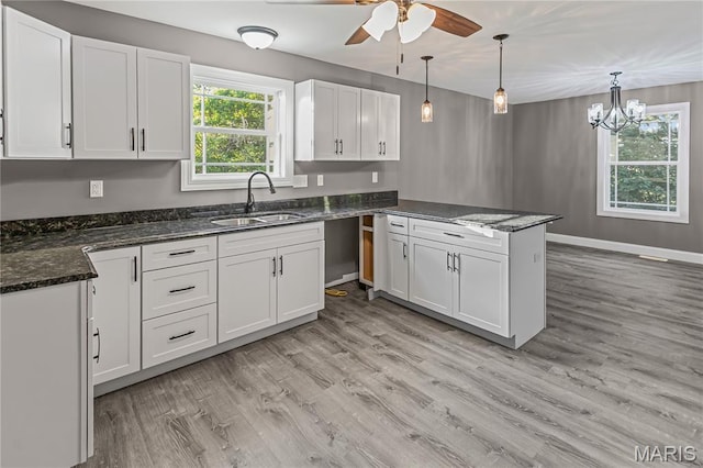 1127 Redwing Ct, Grafton, IL 62037 - kitchen featuring a peninsula, ceiling fan, light wood-style flooring, and white cabinets