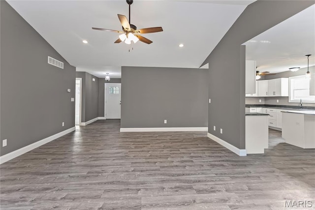 1127 Redwing Ct, Grafton, IL 62037 - unfurnished living room with vaulted ceiling, a ceiling fan, wood finished floors, and recessed lighting