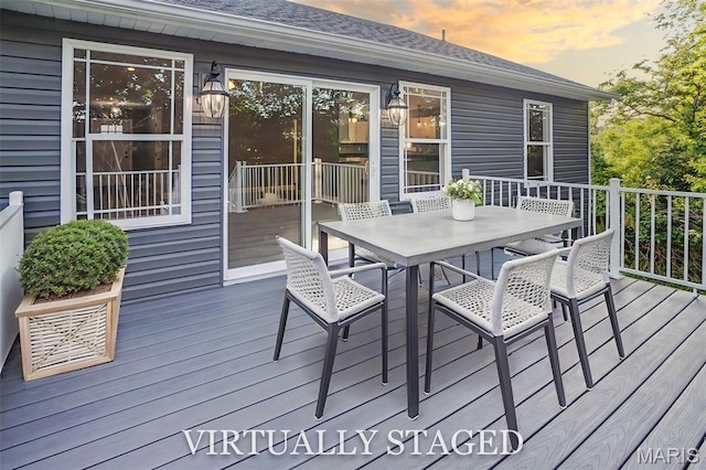 1127 Redwing Ct, Grafton, IL 62037 - deck at dusk featuring outdoor dining space