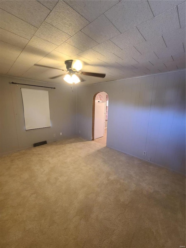 2709 Ralph St, Granite City, IL 62040 - empty room featuring arched walkways, ceiling fan, and carpet