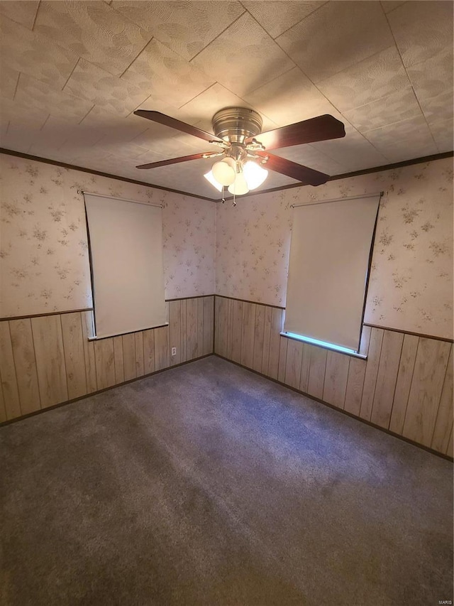 2709 Ralph St, Granite City, IL 62040 - unfurnished room with wainscoting, wallpapered walls, wooden walls, a ceiling fan, and carpet