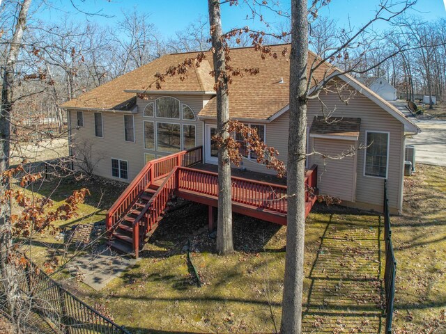 814 Marti Dr, Rolla, MO 65401 - back of property with a wooden deck, stairway, roof with shingles, and a yard