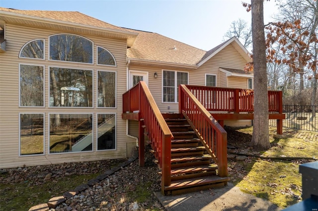 814 Marti Dr, Rolla, MO 65401 - back of house featuring stairway, a wooden deck, roof with shingles, and fence