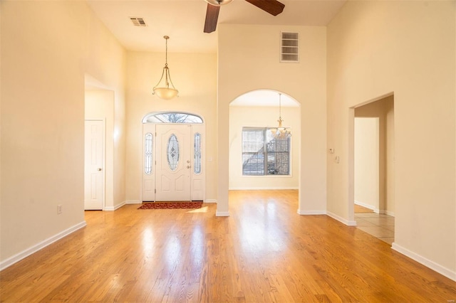 814 Marti Dr, Rolla, MO 65401 - foyer entrance featuring ceiling fan, light wood-type flooring, a high ceiling, arched walkways, and baseboards