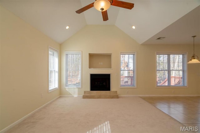 814 Marti Dr, Rolla, MO 65401 - unfurnished living room with a ceiling fan, a fireplace with raised hearth, vaulted ceiling, plenty of natural light, and carpet flooring
