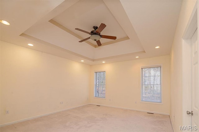 814 Marti Dr, Rolla, MO 65401 - unfurnished room with light carpet, a tray ceiling, a ceiling fan, baseboards, and recessed lighting