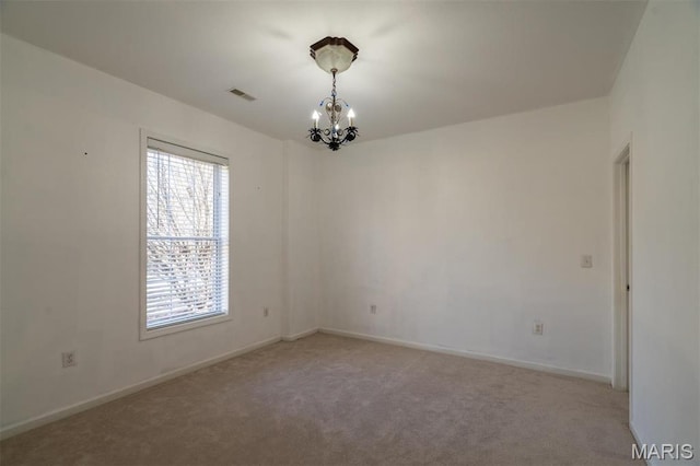 814 Marti Dr, Rolla, MO 65401 - carpeted spare room featuring a chandelier and baseboards