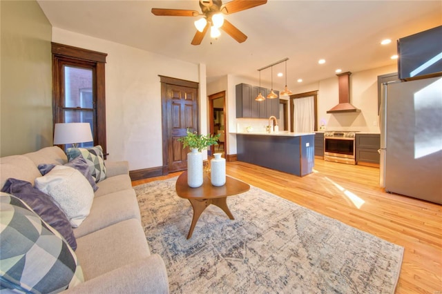 3834 De Tonty St, Saint Louis, MO 63110 - living room with light wood-style floors, ceiling fan, recessed lighting, and baseboards