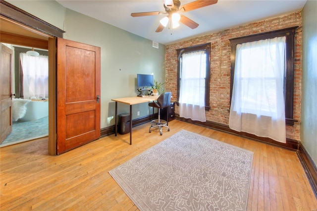 3834 De Tonty St, Saint Louis, MO 63110 - office area featuring brick wall, ceiling fan, light wood finished floors, and baseboards