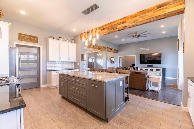 101 Lauren Grace Ct, Elsberry, MO 63343 - kitchen featuring white cabinetry, ceiling fan, light stone counters, freestanding refrigerator, and backsplash