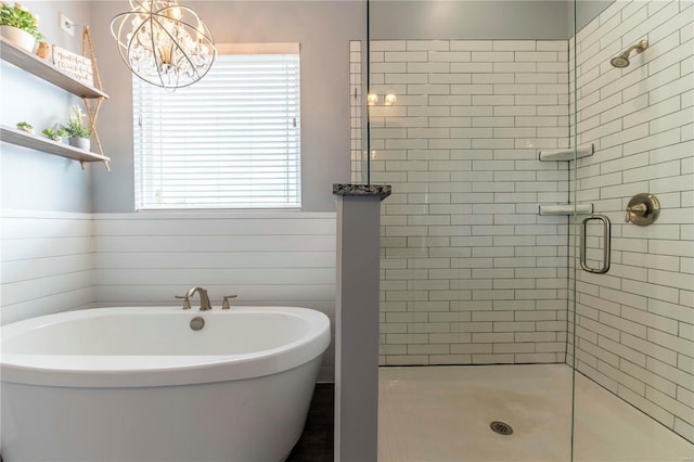 101 Lauren Grace Ct, Elsberry, MO 63343 - bathroom featuring a stall shower, a soaking tub, and a chandelier