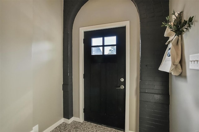 4211 Norfolk Ave, Saint Louis, MO 63110 - entrance foyer with baseboards, carpet, and arched walkways