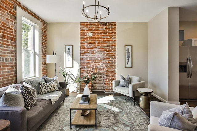 4211 Norfolk Ave, Saint Louis, MO 63110 - living area featuring wood finished floors, a chandelier, brick wall, and baseboards