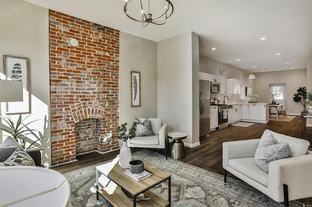 4211 Norfolk Ave, Saint Louis, MO 63110 - living area with dark wood finished floors, a chandelier, baseboards, recessed lighting, and a brick fireplace