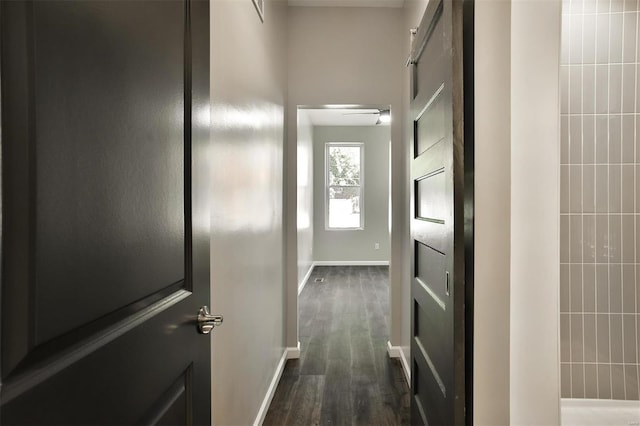 4211 Norfolk Ave, Saint Louis, MO 63110 - hall featuring dark wood-style flooring, baseboards, and a barn door