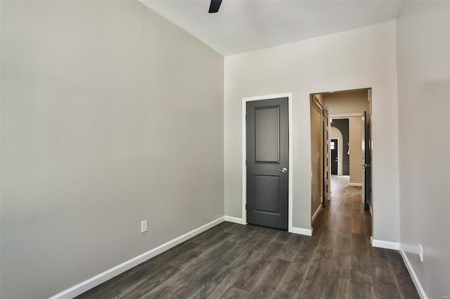 4211 Norfolk Ave, Saint Louis, MO 63110 - unfurnished room with ceiling fan, dark wood-style floors, baseboards, and arched walkways