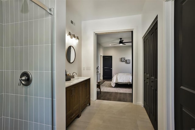 4211 Norfolk Ave, Saint Louis, MO 63110 - full bathroom with ceiling fan, a tile shower, vanity, and connected bathroom