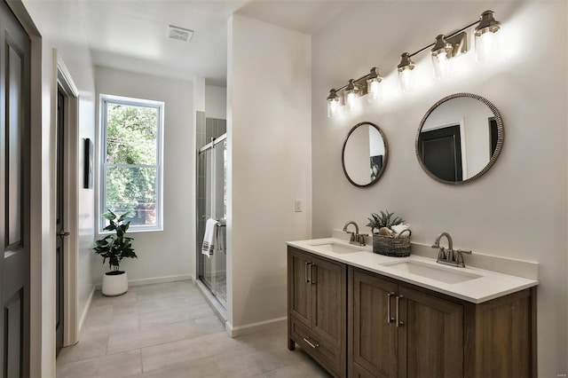 4211 Norfolk Ave, Saint Louis, MO 63110 - bathroom featuring a shower stall, tile patterned floors, baseboards, and double vanity