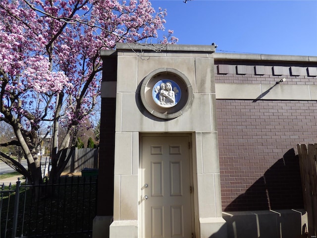 4969 Pershing Pl Unit 1, Saint Louis, MO 63108 - doorway to property with brick siding and fence
