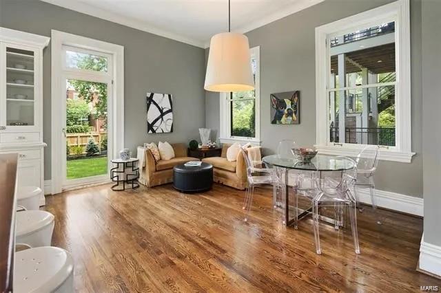 4969 Pershing Pl Unit 1, Saint Louis, MO 63108 - living area with wood finished floors, ornamental molding, and baseboards