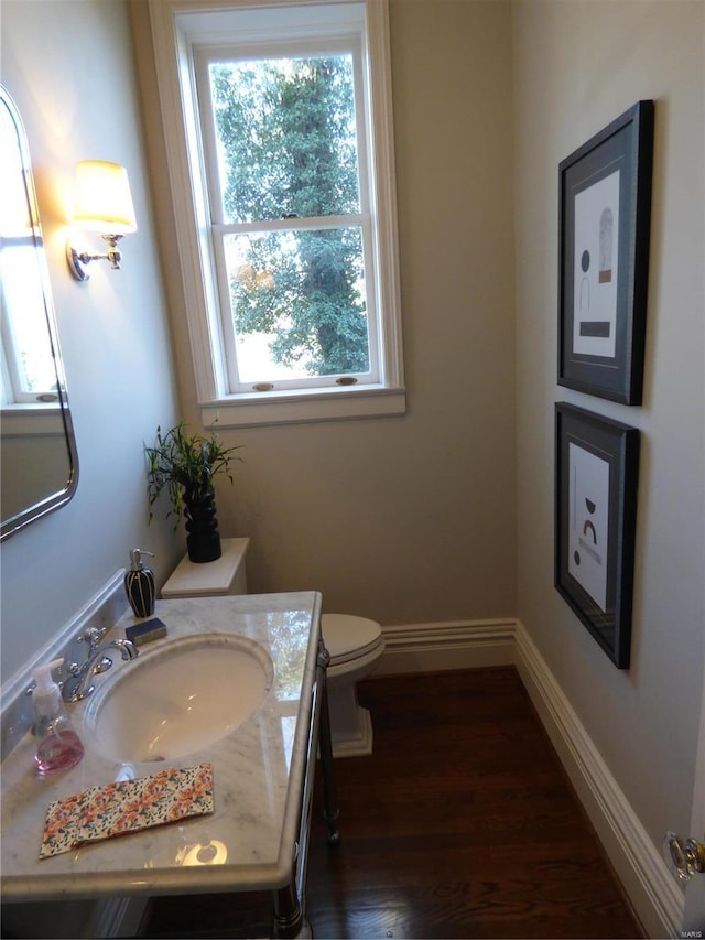 4969 Pershing Pl Unit 1, Saint Louis, MO 63108 - half bathroom featuring plenty of natural light, vanity, wood finished floors, and toilet