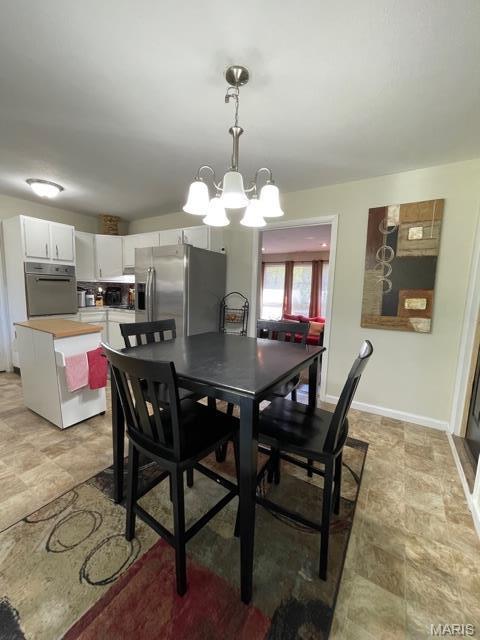 725 Valencia Ave, Saint Louis, MO 63138 - dining space featuring a chandelier and baseboards