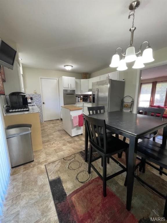 725 Valencia Ave, Saint Louis, MO 63138 - dining area with a chandelier and stone finish flooring