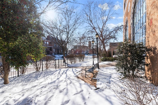 4901 Washington Blvd Unit 2C, Saint Louis, MO 63108 - snowy yard featuring fence