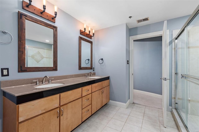 4901 Washington Blvd Unit 2C, Saint Louis, MO 63108 - bathroom with tile patterned flooring, a shower stall, double vanity, and baseboards