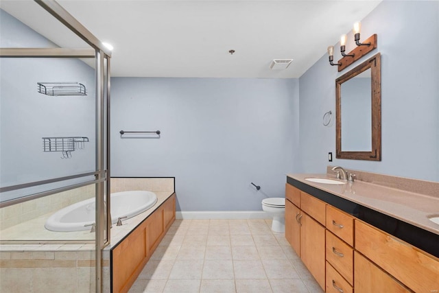 4901 Washington Blvd Unit 2C, Saint Louis, MO 63108 - full bathroom with tile patterned floors, a garden tub, toilet, double vanity, and baseboards