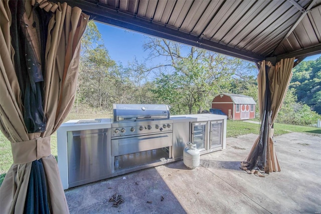 2251 County Road 6670, Salem, MO 65560 - view of patio with an outdoor kitchen, a storage unit, an outdoor structure, and grilling area