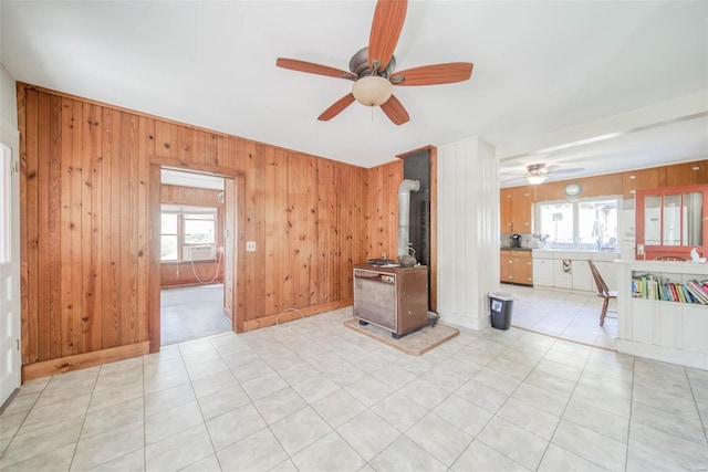 2251 County Road 6670, Salem, MO 65560 - unfurnished living room with a wood stove, ceiling fan, and wood walls