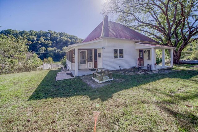 2251 County Road 6670, Salem, MO 65560 - rear view of house featuring a sunroom, a patio area, a chimney, and metal roof