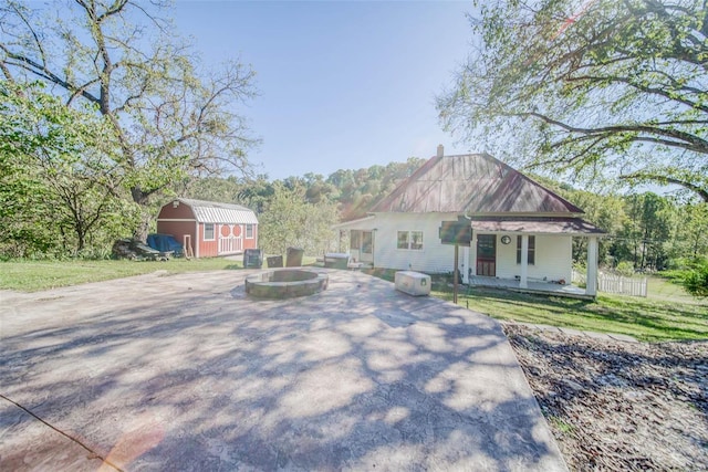 2251 County Road 6670, Salem, MO 65560 - bungalow-style home featuring a storage shed, an outbuilding, metal roof, an outdoor fire pit, and a front yard
