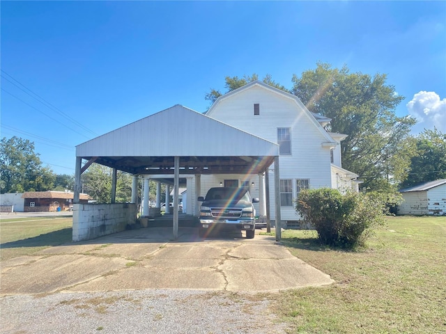 101 E Cedar St, Bertrand, MO 63823 - view of front facade with a front lawn, concrete driveway, and a gambrel roof