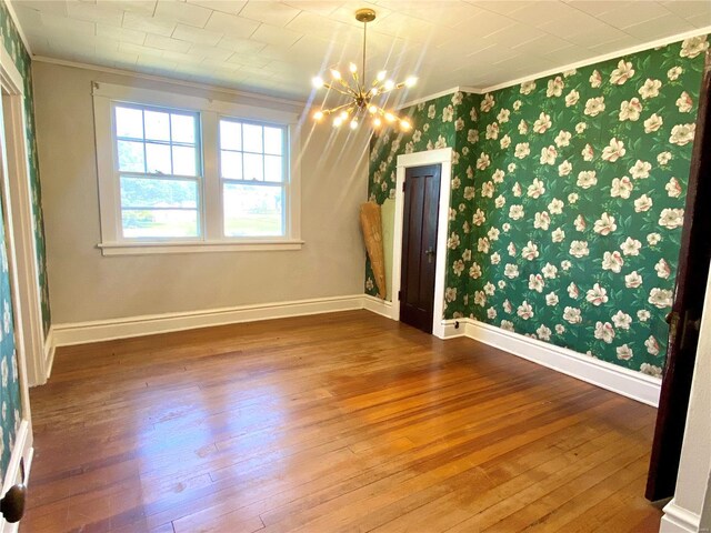 101 E Cedar St, Bertrand, MO 63823 - unfurnished dining area featuring ornamental molding, a chandelier, hardwood / wood-style flooring, baseboards, and wallpapered walls