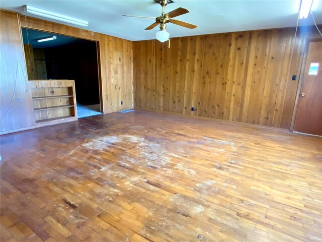 101 E Cedar St, Bertrand, MO 63823 - spare room featuring wood finished floors, a ceiling fan, and wood walls